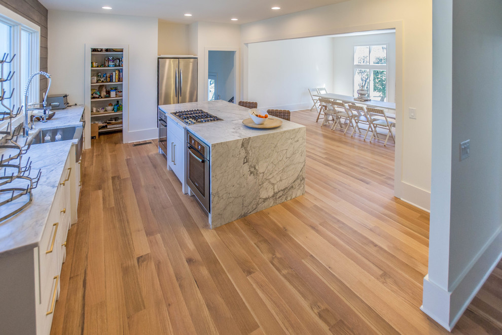 This is an example of a large contemporary kitchen in Atlanta with medium hardwood floors, with island and brown floor.