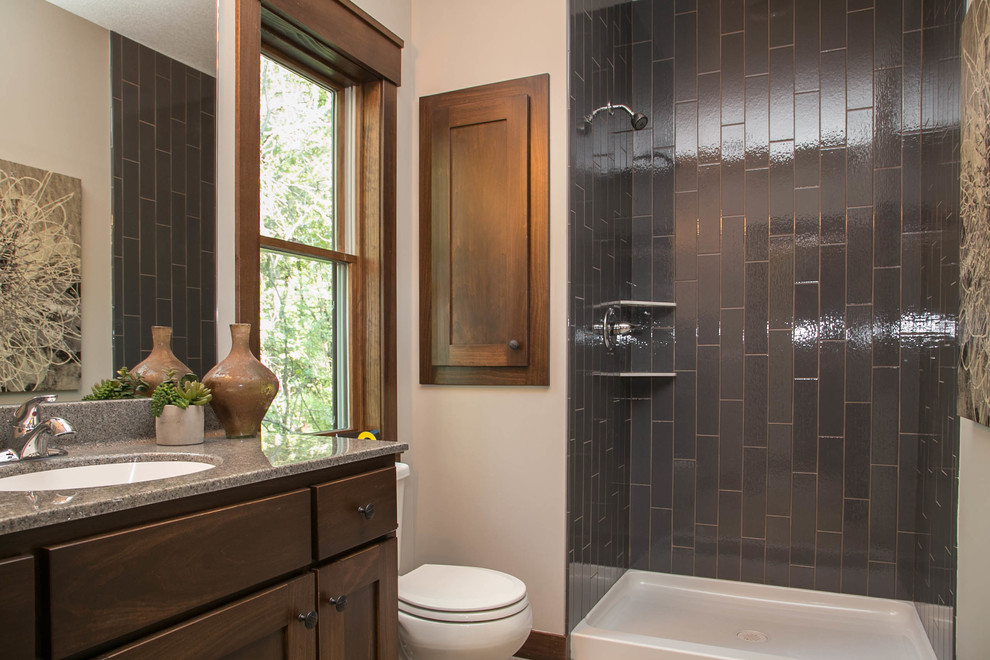 Example of a transitional kids' gray tile and ceramic tile ceramic tile bathroom design in Minneapolis with an undermount sink, recessed-panel cabinets, medium tone wood cabinets, granite countertops, a one-piece toilet and gray walls