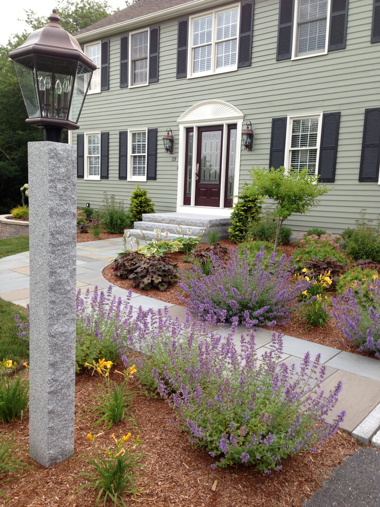 Large traditional front yard full sun garden in Boston with a garden path and concrete pavers for spring.