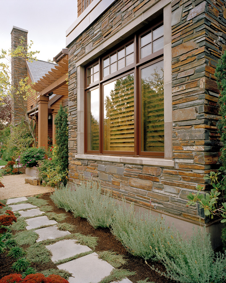 Inspiration for an arts and crafts three-storey brown exterior in Seattle with mixed siding and a gable roof.