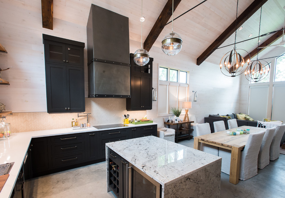 Large beach style u-shaped open plan kitchen in Minneapolis with an undermount sink, shaker cabinets, grey cabinets, quartz benchtops, beige splashback, stone tile splashback, stainless steel appliances, concrete floors and with island.