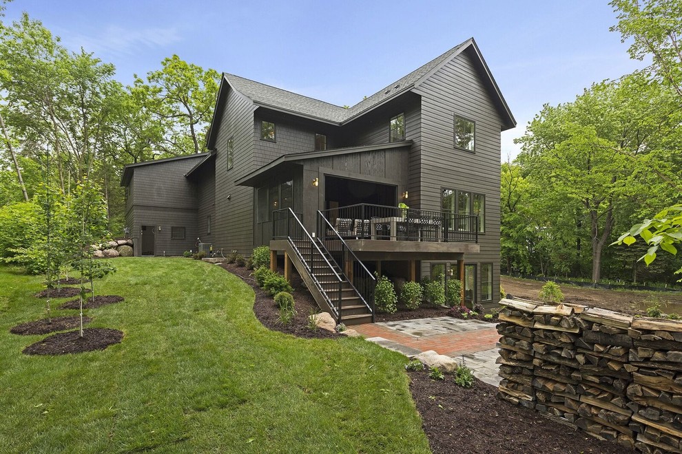 Large transitional brown two-story wood house exterior idea in Minneapolis with a hip roof and a shingle roof