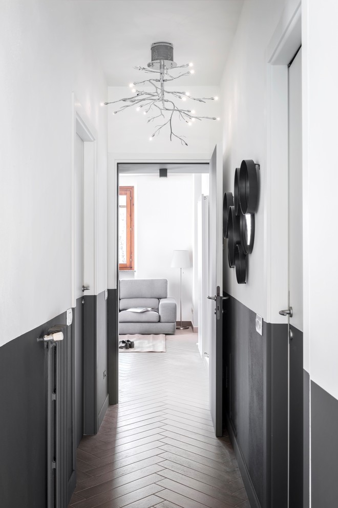 This is an example of a small contemporary hallway in Milan with porcelain floors, grey floor and brown walls.
