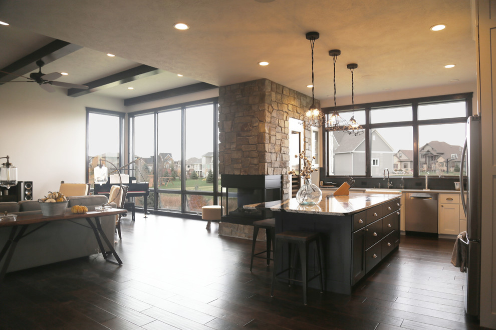 Example of a mid-sized transitional l-shaped dark wood floor eat-in kitchen design with a farmhouse sink, recessed-panel cabinets, white cabinets, granite countertops, black backsplash, porcelain backsplash, stainless steel appliances and an island