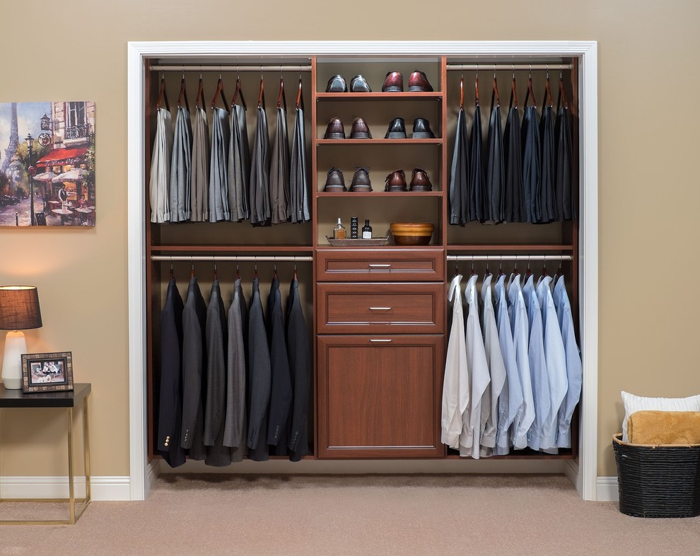 Reach-in closet - small transitional men's carpeted reach-in closet idea in Denver with recessed-panel cabinets and medium tone wood cabinets