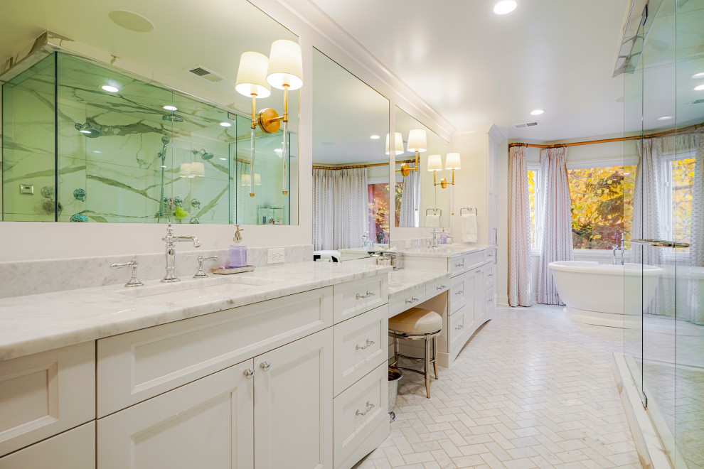 Large traditional master bathroom in Denver with shaker cabinets, white cabinets, a freestanding tub, white walls, porcelain floors, an undermount sink, white floor, a double vanity and a built-in vanity.