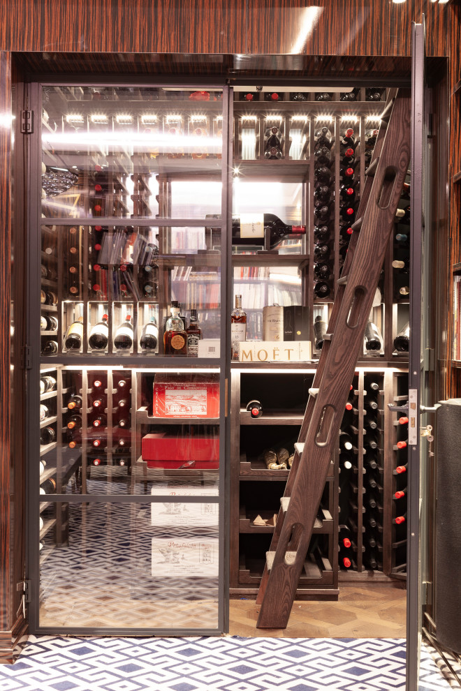 Design ideas for a small contemporary wine cellar in London with dark hardwood flooring, storage racks, brown floors and feature lighting.