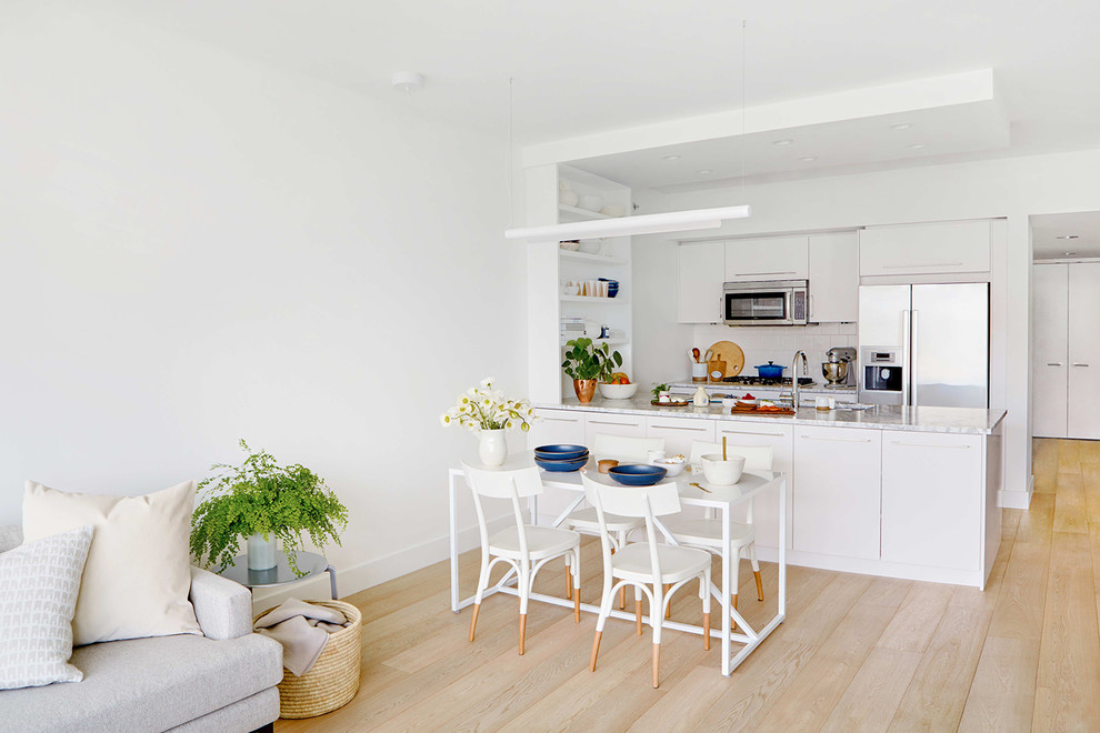 Example of a danish light wood floor and beige floor great room design in Seattle with white walls