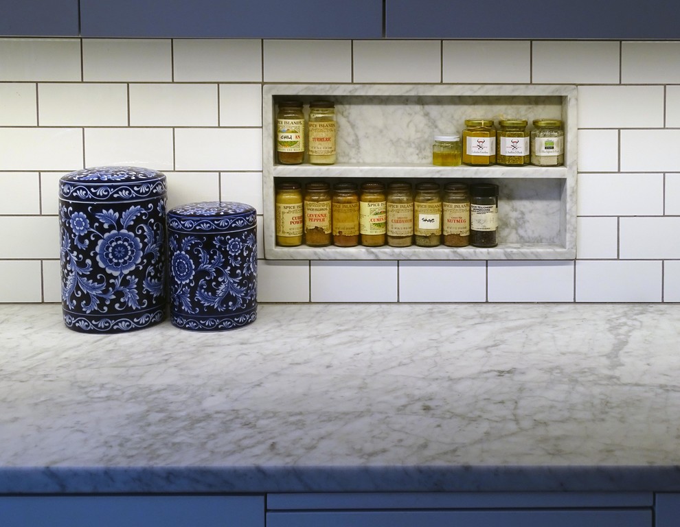 Design ideas for a modern kitchen in Minneapolis with a single-bowl sink, marble benchtops, white splashback, subway tile splashback, stainless steel appliances and dark hardwood floors.