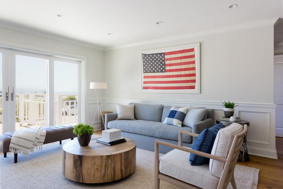 Example of a transitional light wood floor and beige floor living room design in Los Angeles with white walls, no fireplace and no tv
