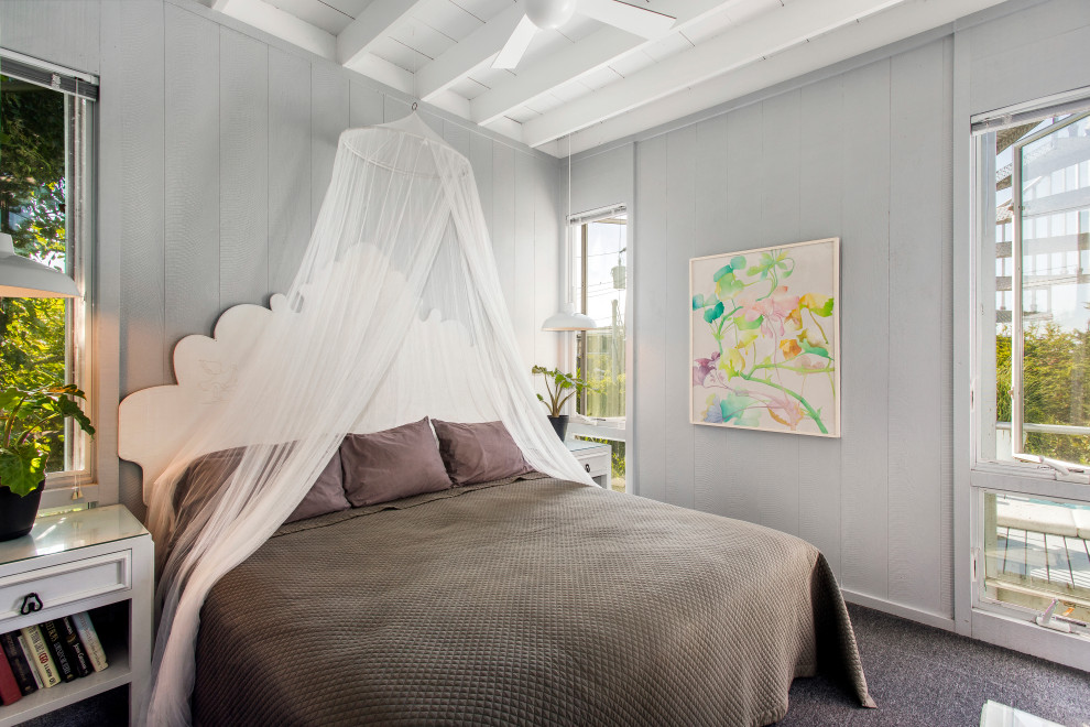 Tropical bedroom in New York with grey walls, carpet, grey floor, exposed beam and planked wall panelling.