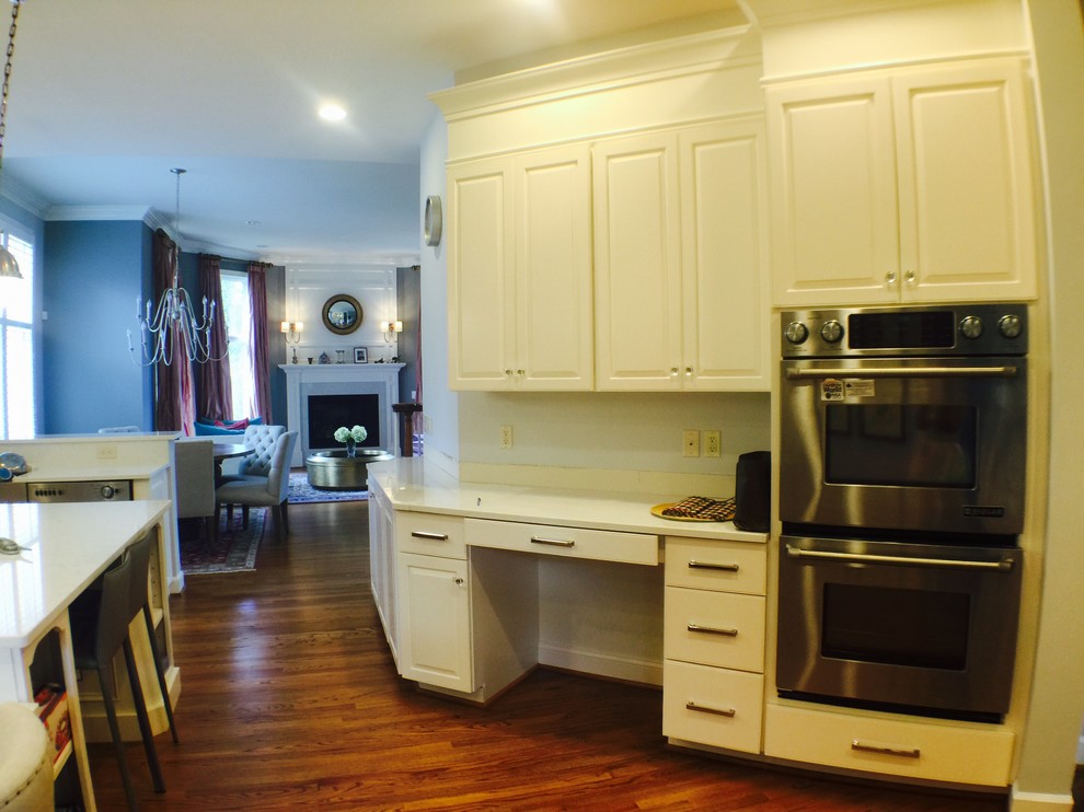 Open concept kitchen - large transitional u-shaped medium tone wood floor open concept kitchen idea in DC Metro with an undermount sink, raised-panel cabinets, white cabinets, quartzite countertops, stainless steel appliances and an island