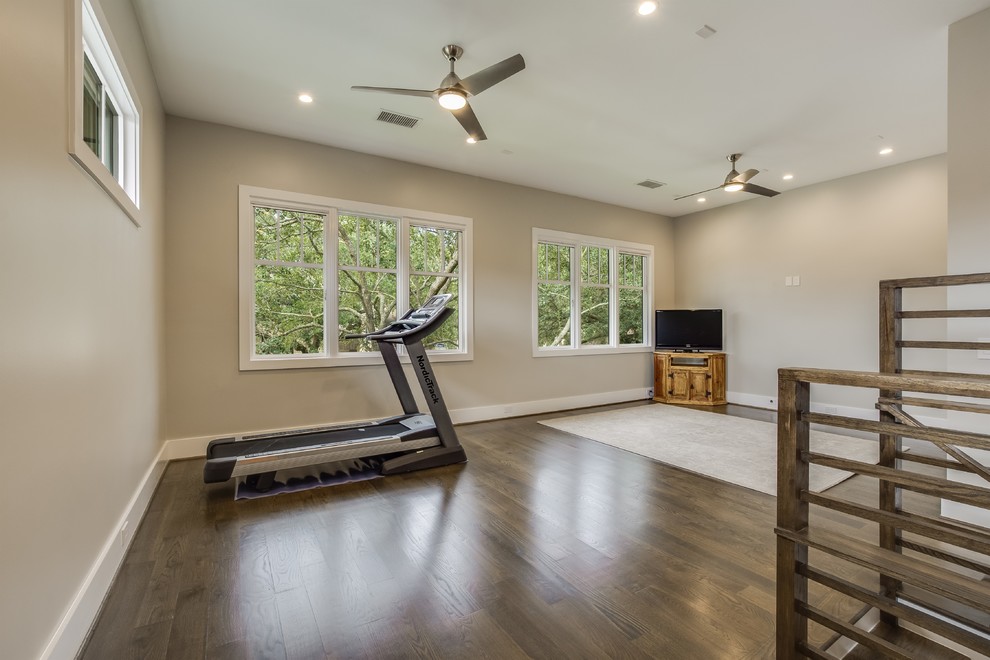 Mid-sized midcentury multipurpose gym with beige walls, medium hardwood floors and brown floor.
