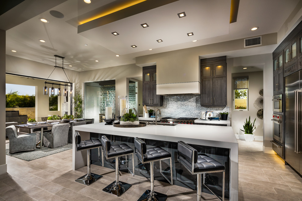 Inspiration for a large contemporary eat-in kitchen in Orange County with shaker cabinets, stone slab splashback, stainless steel appliances, ceramic floors, with island and grey floor.