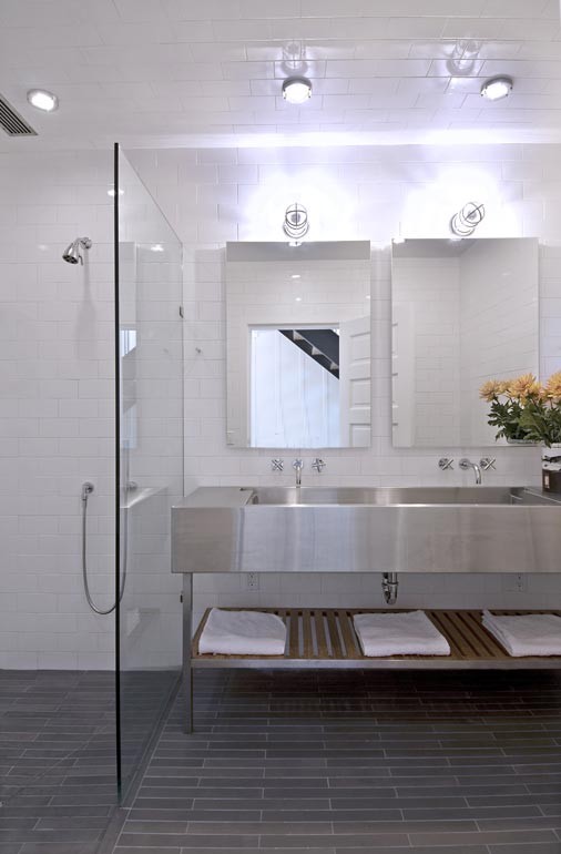 Large contemporary bathroom in San Francisco with a curbless shower, white tile, ceramic tile, white walls, ceramic floors, an integrated sink, stainless steel benchtops, grey floor, an open shower, a double vanity and a freestanding vanity.