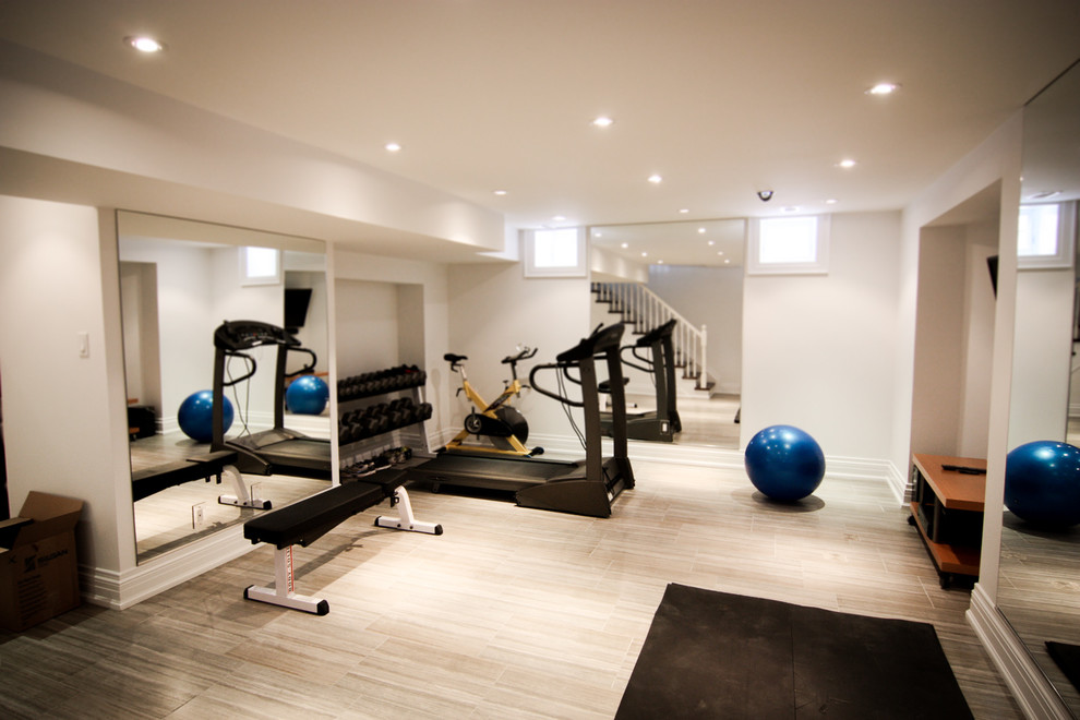 This is an example of a small traditional multipurpose gym in Toronto with white walls and ceramic floors.