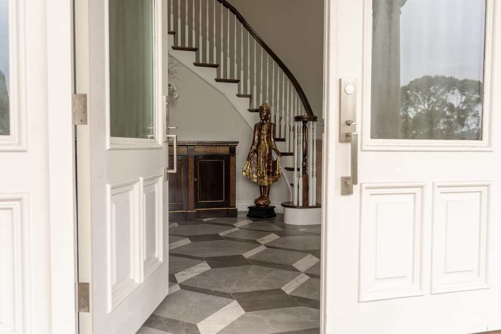 This is an example of a large contemporary foyer in San Francisco with grey walls, porcelain floors, a double front door, a white front door and grey floor.