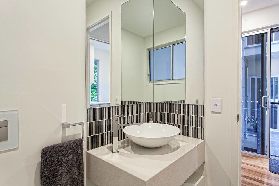 Inspiration for an expansive modern kids bathroom in Brisbane with a pedestal sink, recessed-panel cabinets, white cabinets, marble benchtops, a corner shower, white tile, stone tile and marble floors.