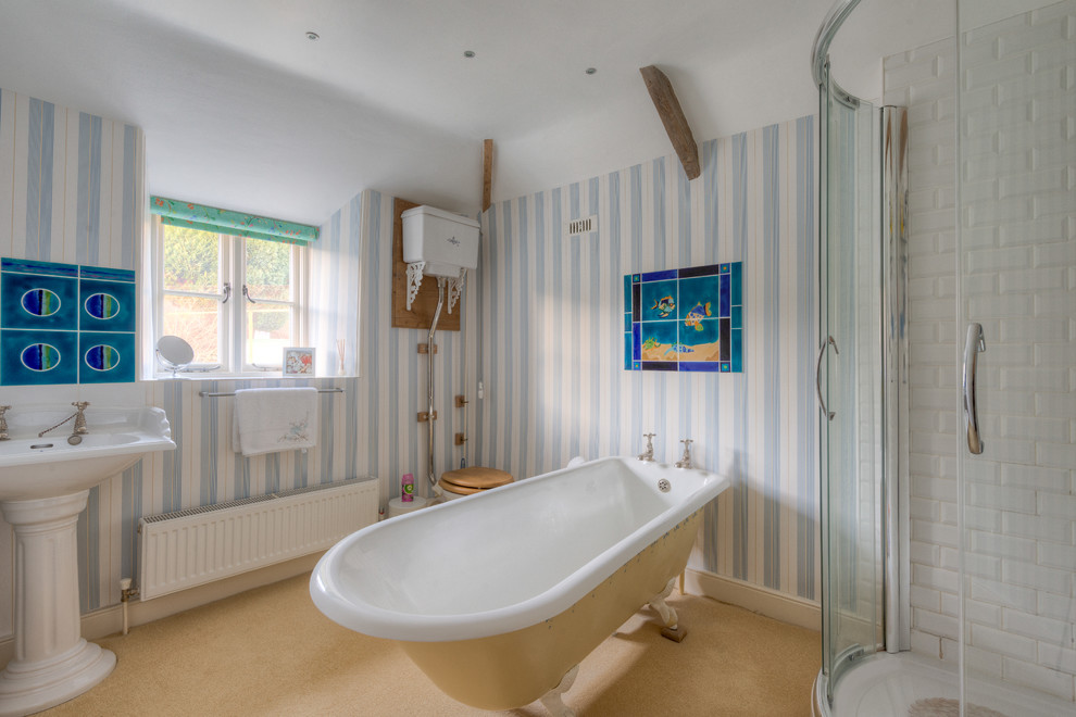 Country bathroom in Devon with a pedestal sink, a claw-foot tub and a corner shower.