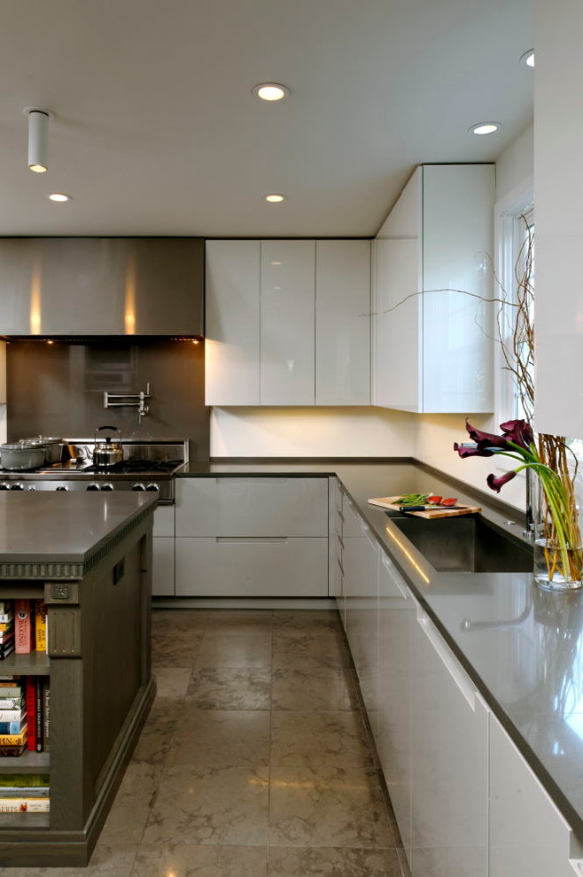 Mid-sized modern u-shaped eat-in kitchen in DC Metro with an undermount sink, grey cabinets, black splashback, stainless steel appliances, ceramic floors, with island, flat-panel cabinets, solid surface benchtops and stone slab splashback.