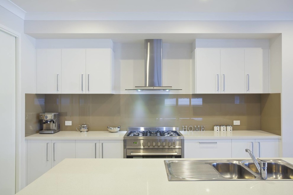 Inspiration for a large transitional u-shaped medium tone wood floor and green floor eat-in kitchen remodel in Orange County with an undermount sink, beaded inset cabinets, white cabinets, quartz countertops, green backsplash, ceramic backsplash, stainless steel appliances and no island