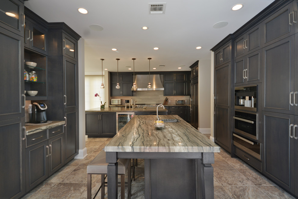 Large transitional l-shaped eat-in kitchen in New York with raised-panel cabinets, dark wood cabinets, quartzite benchtops, grey splashback, stainless steel appliances, multiple islands, a farmhouse sink and travertine floors.