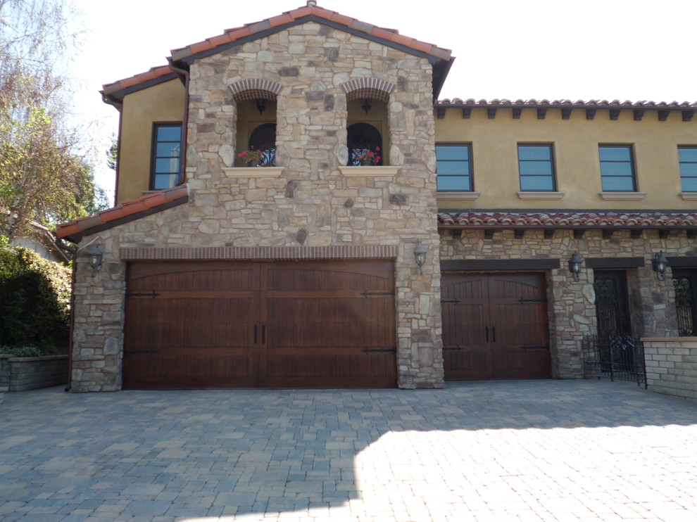 Photo of a large mediterranean attached three-car garage in Los Angeles.