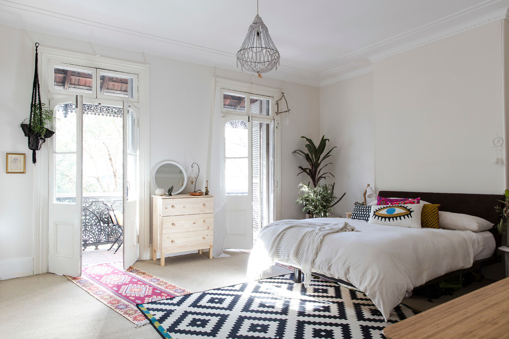 Inspiration for an eclectic bedroom in Sydney with beige walls and carpet.