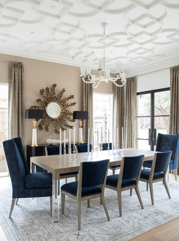 This is an example of a transitional separate dining room in Dallas with white walls, light hardwood floors and beige floor.