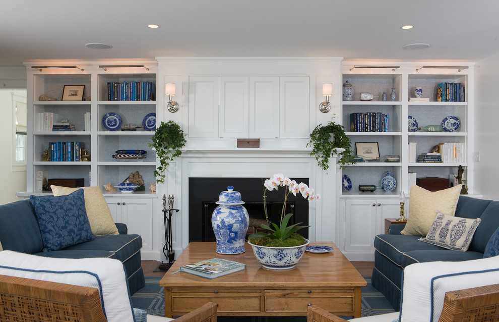Photo of a large beach style formal open concept living room in Boston with white walls, a standard fireplace, a wood fireplace surround and a built-in media wall.