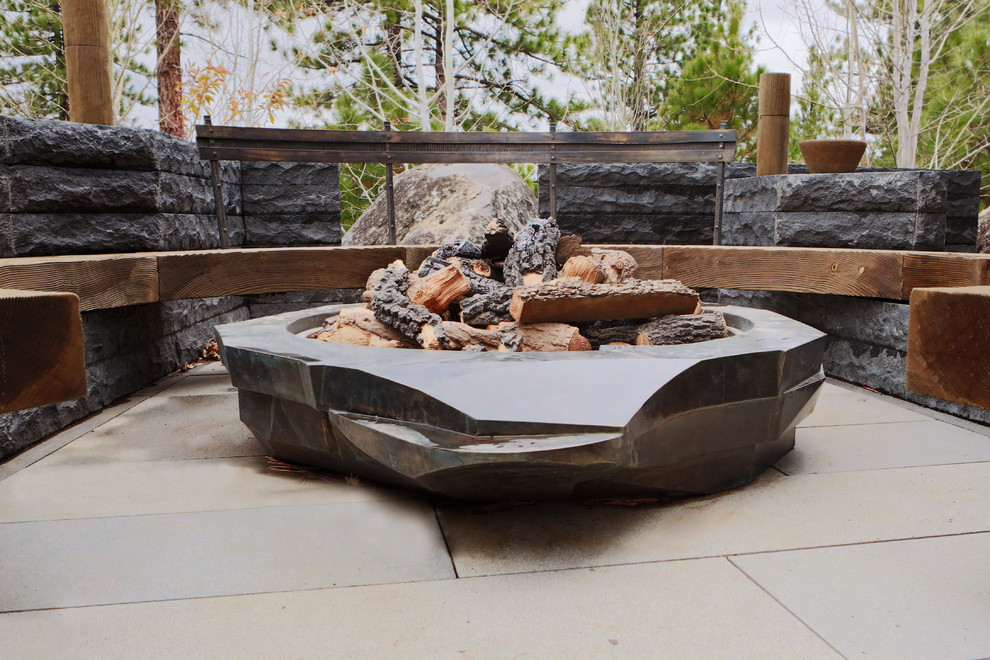 Photo of an expansive contemporary patio in San Francisco with a fire feature, natural stone pavers and no cover.