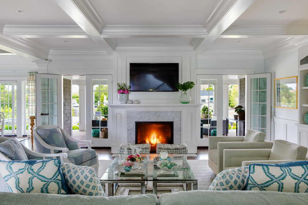 Inspiration for a beach style open concept living room in Providence with white walls, a standard fireplace, a stone fireplace surround and a wall-mounted tv.