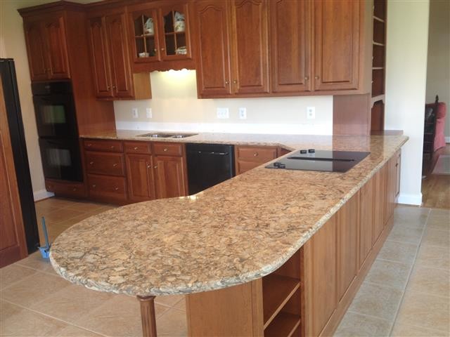 Example of a kitchen design in DC Metro with a double-bowl sink, beaded inset cabinets, medium tone wood cabinets, granite countertops, black appliances and a peninsula