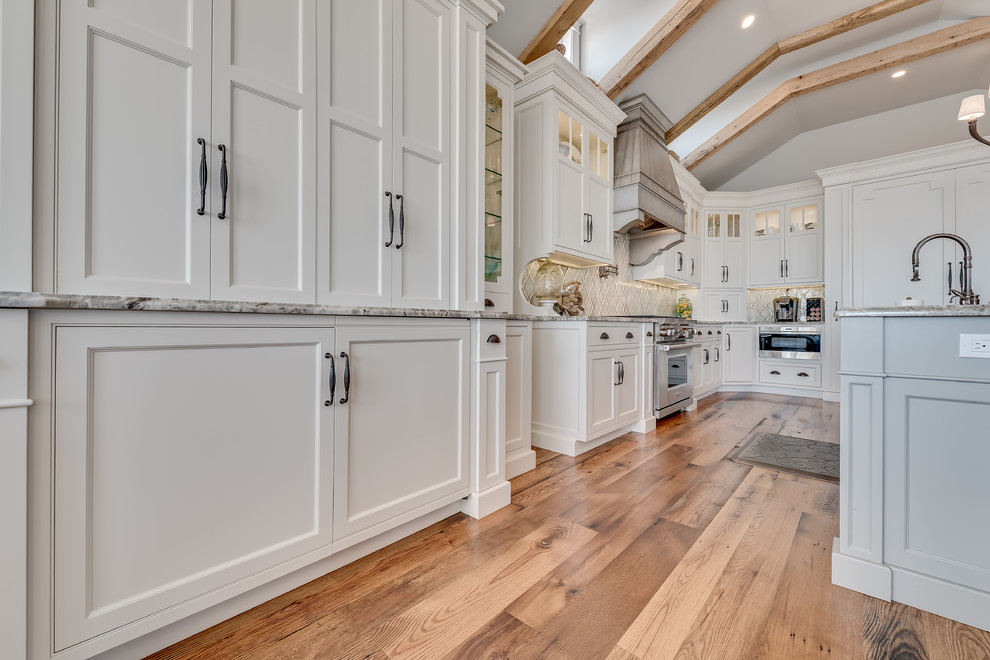 Example of a huge beach style eat-in kitchen design in Philadelphia with flat-panel cabinets, white cabinets, granite countertops, gray backsplash, porcelain backsplash, paneled appliances and an island