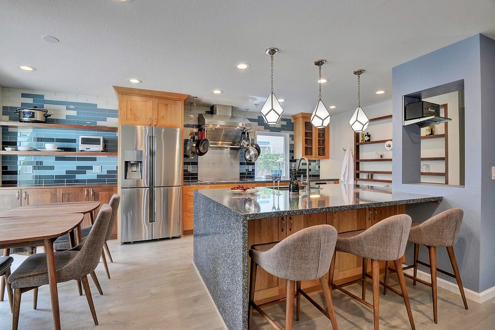 Photo of a mid-sized contemporary eat-in kitchen in San Francisco with a single-bowl sink, shaker cabinets, quartz benchtops, glass tile splashback, stainless steel appliances and with island.
