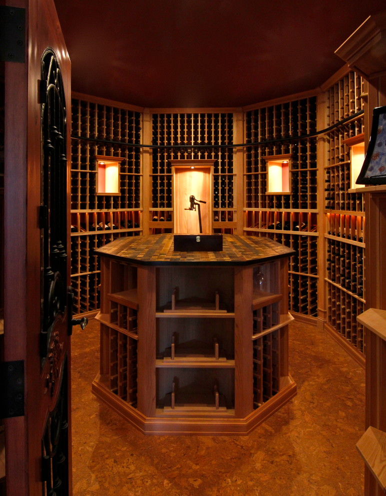 This is an example of a large arts and crafts wine cellar in Seattle with cork floors.