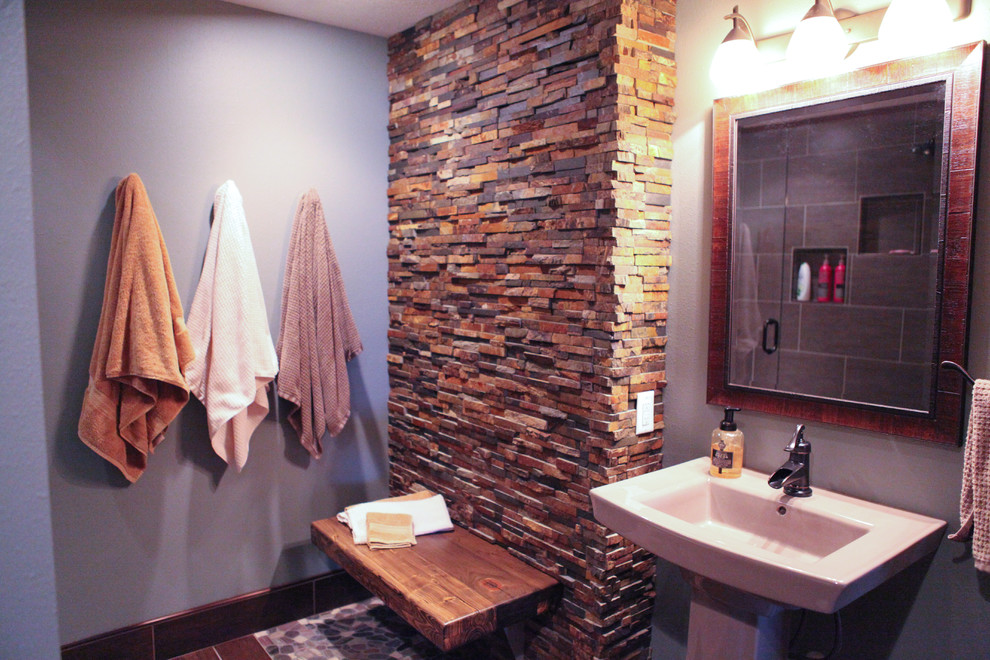 Corner shower - mid-sized rustic 3/4 multicolored tile and pebble tile porcelain tile corner shower idea with open cabinets, dark wood cabinets, a two-piece toilet, blue walls and a pedestal sink