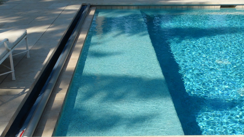 Mid-sized traditional backyard rectangular lap pool in Chicago with a hot tub and natural stone pavers.