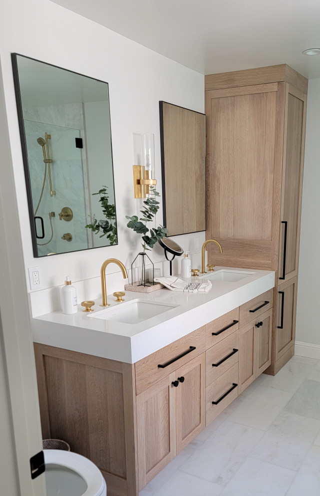 Inspiration for a medium sized contemporary ensuite bathroom in San Francisco with shaker cabinets, light wood cabinets, a freestanding bath, a walk-in shower, white walls, marble flooring, a submerged sink, quartz worktops, white floors, a hinged door, white worktops, a shower bench, double sinks and a built in vanity unit.