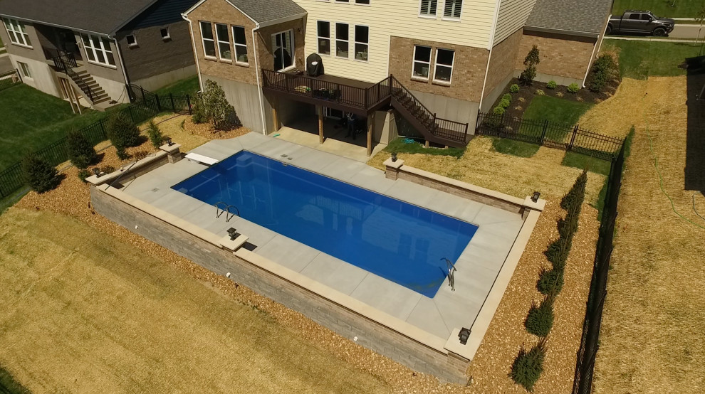 Großer Moderner Schwimmteich hinter dem Haus in rechteckiger Form mit Betonplatten in Sonstige