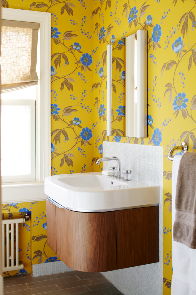 Inspiration for an eclectic white tile corner shower remodel in New York with a wall-mount sink, furniture-like cabinets, medium tone wood cabinets and solid surface countertops