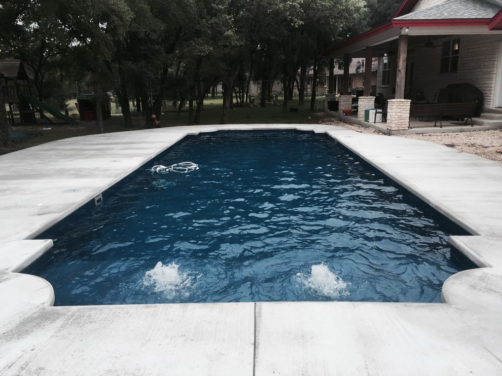 Pool - large modern indoor concrete and custom-shaped indoor pool idea in Austin
