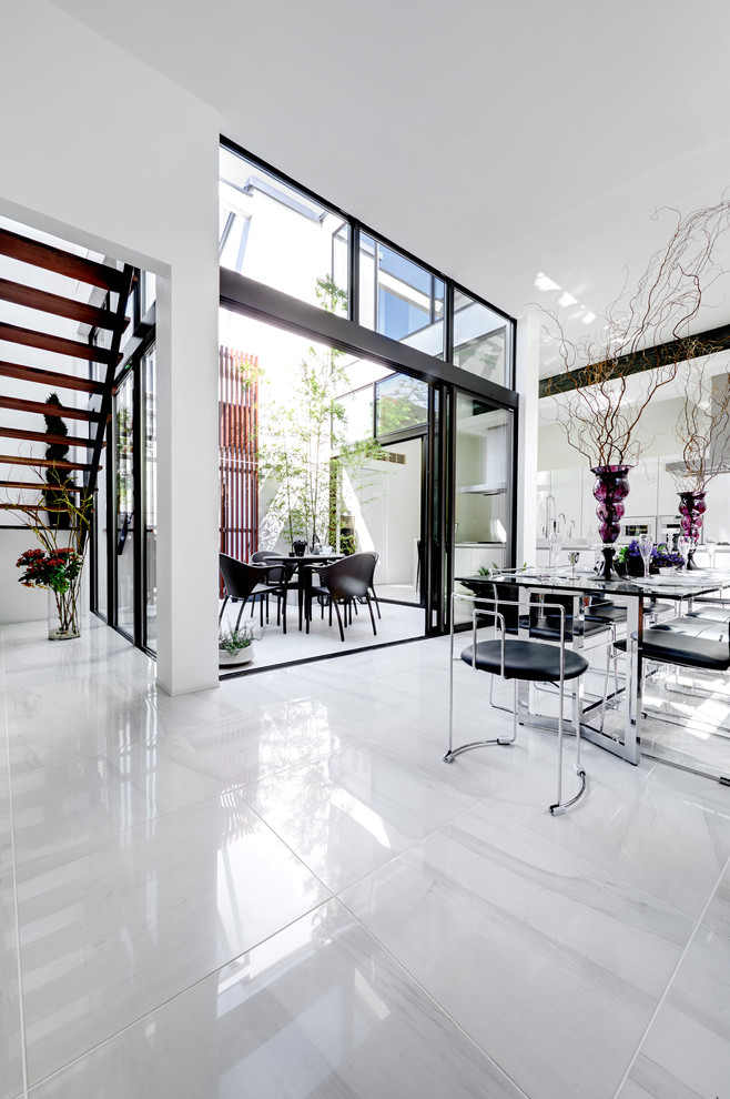 Inspiration for a large contemporary kitchen/dining combo in Tokyo with white walls, marble floors and no fireplace.