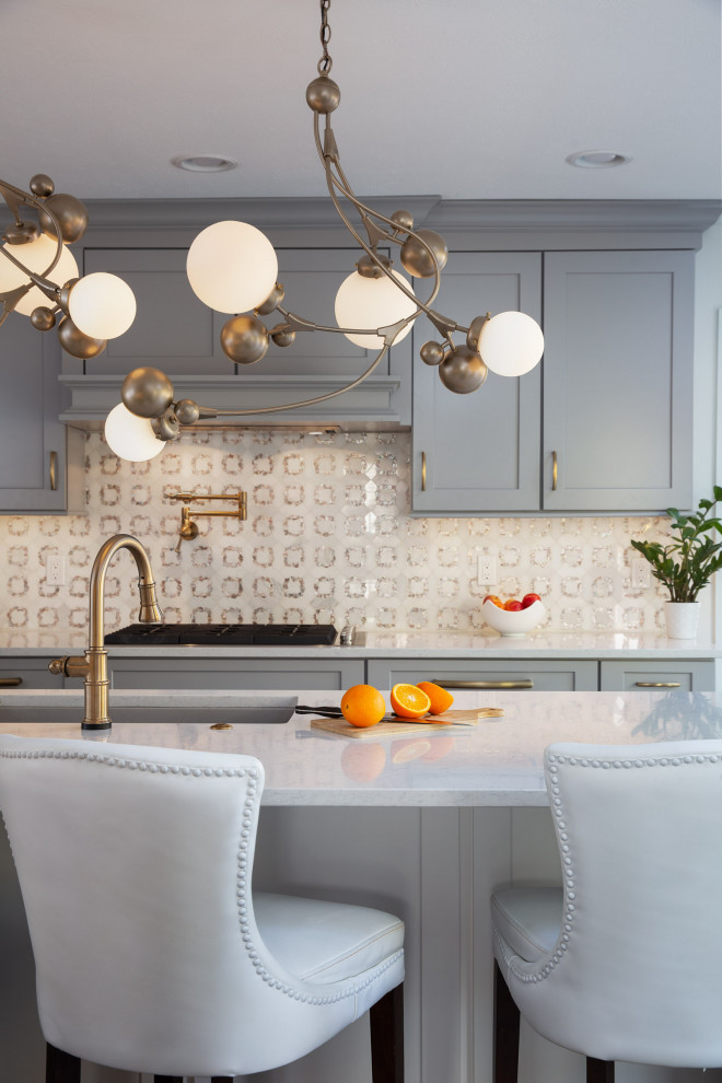 Transitional dark wood floor and brown floor kitchen photo with a drop-in sink, shaker cabinets, gray cabinets, quartzite countertops, white backsplash, mosaic tile backsplash, stainless steel appliances, an island and white countertops