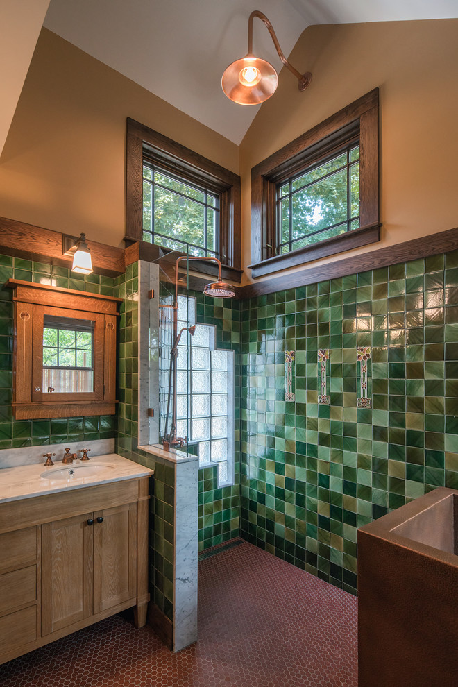 Mid-sized arts and crafts master bathroom in Boston with an undermount sink, furniture-like cabinets, medium wood cabinets, marble benchtops, a freestanding tub, an open shower, green tile, porcelain tile, yellow walls and ceramic floors.