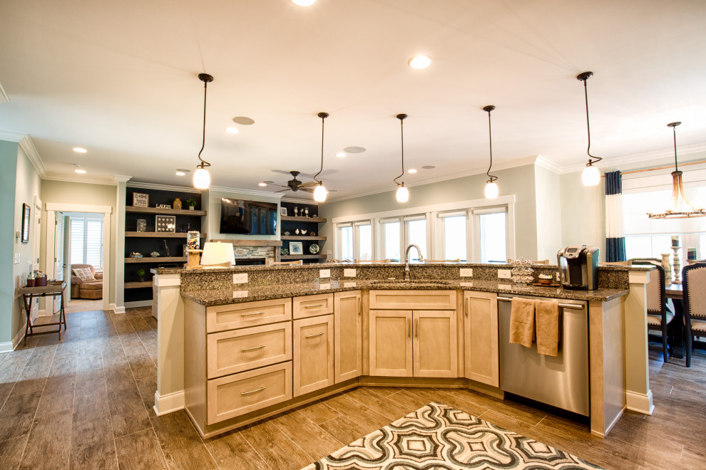 Large transitional single-wall porcelain tile and brown floor open concept kitchen photo with an undermount sink, recessed-panel cabinets, light wood cabinets, granite countertops, white backsplash, subway tile backsplash, stainless steel appliances, an island and gray countertops