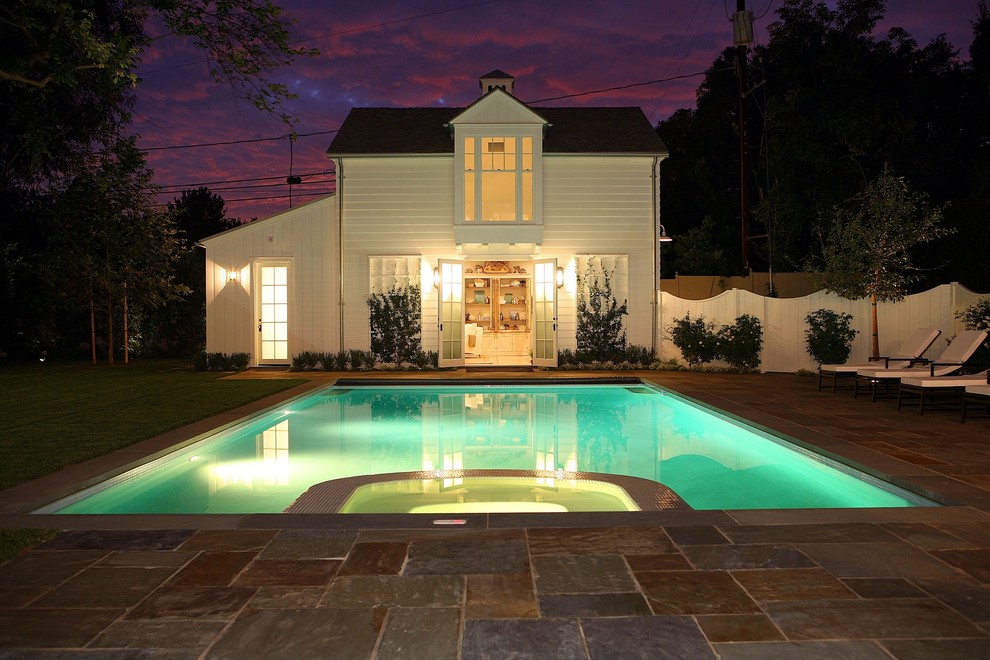 Photo of a traditional rectangular pool in Los Angeles with a pool house.