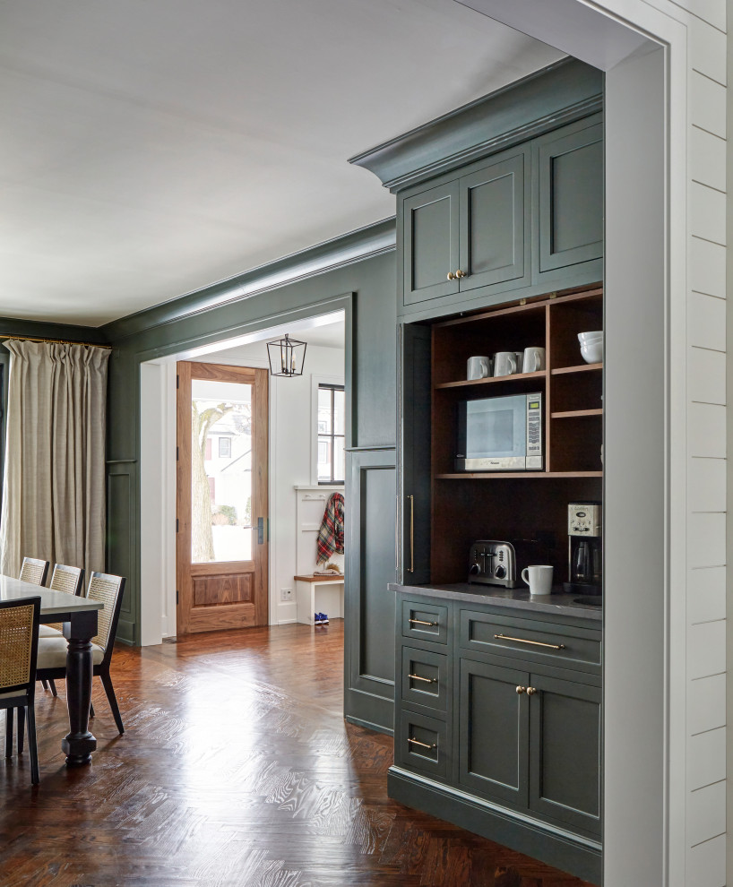 Large country separate dining room in Chicago with green walls, medium hardwood floors and brown floor.