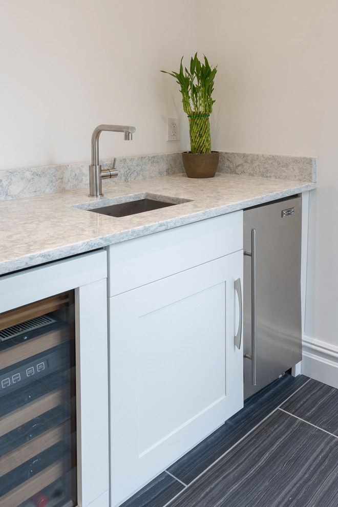 Inspiration for a large contemporary u-shaped home bar in Philadelphia with an undermount sink, shaker cabinets, white cabinets, marble benchtops, blue splashback, glass tile splashback, vinyl floors and grey floor.