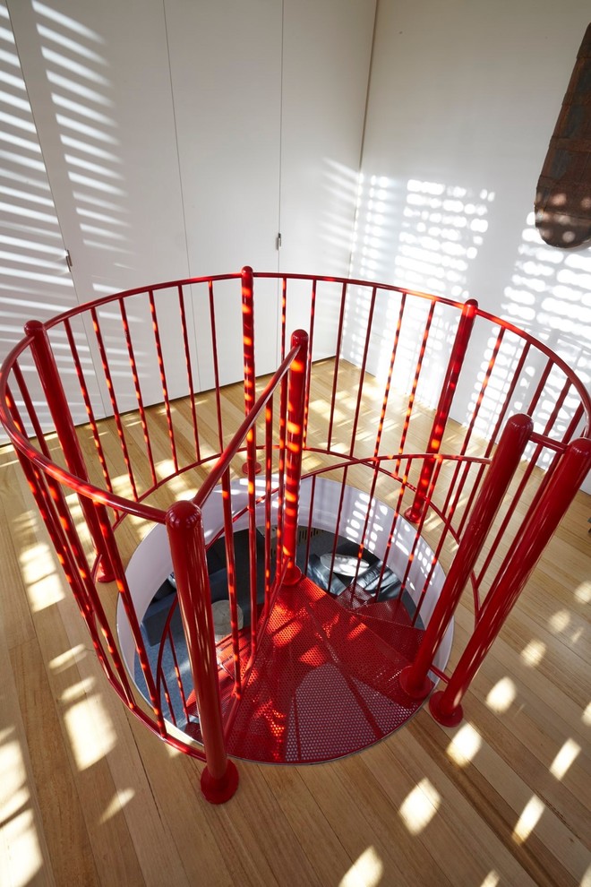 This is an example of a small midcentury metal spiral staircase in Melbourne with metal railing.